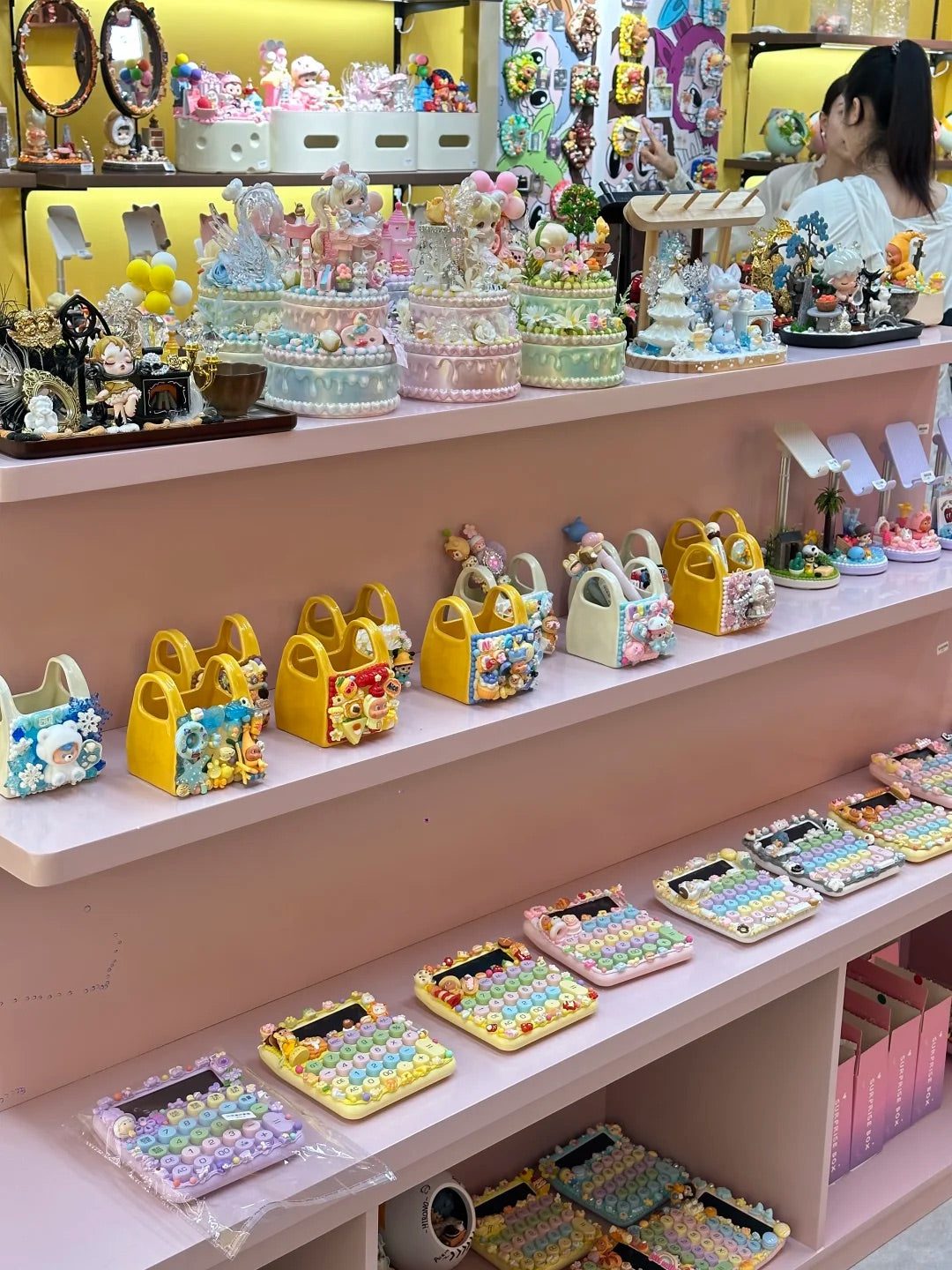 Decoden bags, phone cases and handmade pieces displayed inside a DIY shop